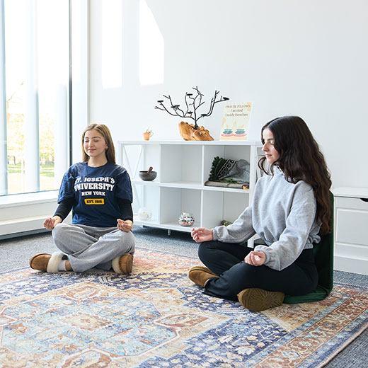 Students meditating in their dorm. Links to Gifts of Life Insurance